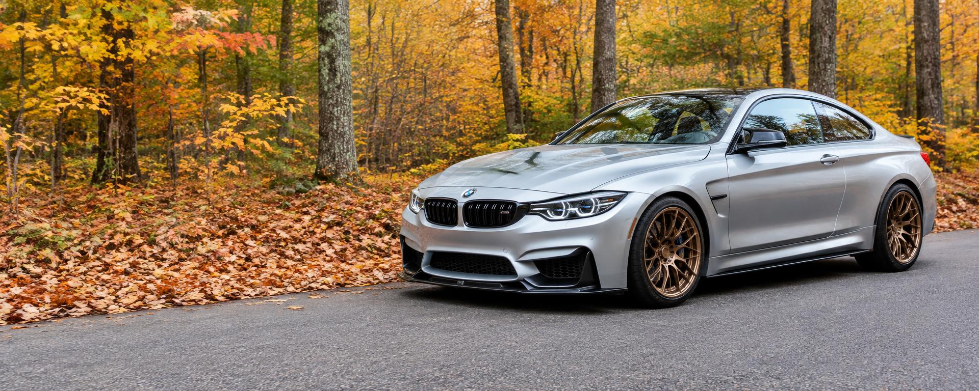 Silver sports coupe with exterior styling on an autumn road